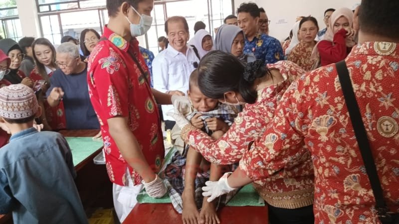 Seorang anak didampingi keluarga saat mengikuti sunatan massal dalam rangka HUT ke-51 PPNI di Aula Kecamatan Dusun Selatan, Senin (17/3).
